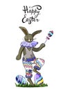 Rabbit in fancy dress  holding a lollypop at one paw and two  colorful eggs with lettering phrase happy easter isolate on white Royalty Free Stock Photo