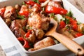 Rabbit baked with mushrooms, sweet pepper and onions macro in a Royalty Free Stock Photo