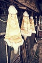Rabbit furs hanging on the hooks in the farm, retro photo filter Royalty Free Stock Photo