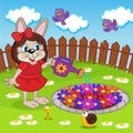 Rabbit girl watering flowers in flowerbed Royalty Free Stock Photo