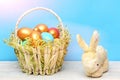 Rabbit, hare toy, spring easter holiday, colorful eggs in basket Royalty Free Stock Photo