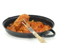 Rabbit leg into a casserole Royalty Free Stock Photo