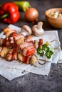 Rabbit meat, bacon and vegetable skewers Royalty Free Stock Photo