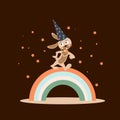 Rabbit wizard in a hat with stars. A cute cartoon rabbit walking forward on a rainbow