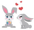 Two cute rabbits. One holding eggs. Isolated obn white. Royalty Free Stock Photo