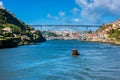 Rabelo Boat approaching the Dom Luis I Bridge in Porto Portugal Royalty Free Stock Photo