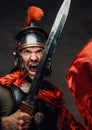 Rabid roman soldier with sword in dark background Royalty Free Stock Photo