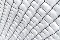 Rabitz mesh covered with snow. Background texture. Royalty Free Stock Photo