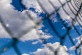 Rabitz metal mesh fence against blue sky background.