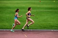 Athletes at 3000 meters race on a stadium 