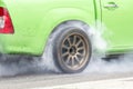 Race car burns rubber off its tires Royalty Free Stock Photo