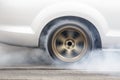 Race car burns rubber off its tires Royalty Free Stock Photo