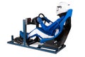 Race driver in blue overall with helmet taining on simracing aluminum simulator rig for video game racing. Motorsport car bucket Royalty Free Stock Photo