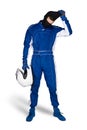 Race driver in blue white motorsport overall shoes gloves and safety crash helmet take off blaclava after finish isolated white