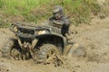 Race four-wheeler driver in puddle of mud