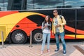 Race man with map and woman with digital camera near travel bus Royalty Free Stock Photo