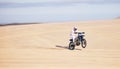 Race, motorcycle and person in desert, action and extreme sport with speed, riding outdoor and mockup space. Adventure