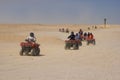 Race on quad in desert