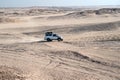 Race in sand desert. Car suv overcomes sand dunes obstacles. Competition racing challenge desert. Car drives offroad