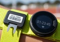 Of a race timing device and a smartwatch on a bright yellow strap Royalty Free Stock Photo