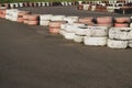 Race track safety barrier. asphalt racing track with red and white tires. colorful tires stack. karting racetrack Royalty Free Stock Photo