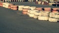 Race track safety barrier. asphalt racing track with red and white tires. colorful tires stack. karting racetrack Royalty Free Stock Photo