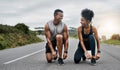 Race you to the end. a sporty young couple tying their shoelaces while exercising outdoors. Royalty Free Stock Photo