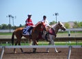 Racehorses and jockeys galloping