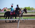 Racehorses and jockeys galloping