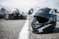 Racer helmet on asphalt, karting sport concept Royalty Free Stock Photo