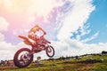 Dirtbike Racers are at start of motorcycles.