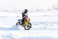 racer on a motorcycle rides in turn of wheels a spray of snow Royalty Free Stock Photo