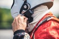 The racer`s hand is wearing a helmet strap for safety in the race