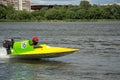 Racer in speed boat go fast along the river