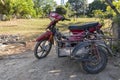 Racha island, Thailand, January 5, 2020: an old rusty red Japanese motorbike with a trailer or sidecar, stands in a
