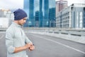 Racing against time. a young jogger checking the time while out for a run in the city.