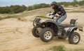 Racing ATV is sand.