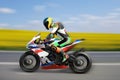 Racing bike rider racing at high speed on a colorful background Royalty Free Stock Photo