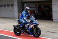Racing bike rider on a sports motorcycle leaves the pits