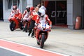 Racing bike rider on a sports motorcycle leaves the pits