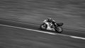 A racing bike speeding round corners in monochrome Royalty Free Stock Photo