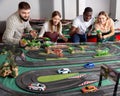 Racing car on the toy race track and emotional players Royalty Free Stock Photo