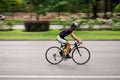Racing cyclist on road, panning