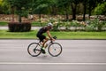 Racing cyclist on road, panning