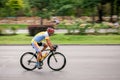 Racing cyclist on road, panning