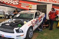 Racing mechanics working on the Mustang