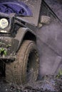 Racing on off-road cars. Part of SUV stuck in dirt, close up. Dirty tire