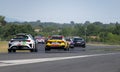 Racing TCR cars group on asphalt racetrack straight