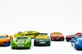 Racing toy cars of various colors scattered on a white background Royalty Free Stock Photo