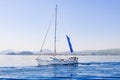 Racing yacht in the sea on blue sky background. Peaceful seascape. Beautiful blue sky over calm sea Royalty Free Stock Photo